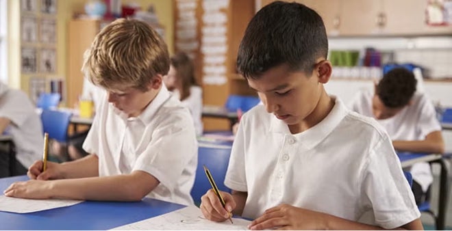 Students writing in classroom