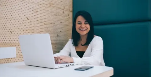 Professional working at laptop in modern office