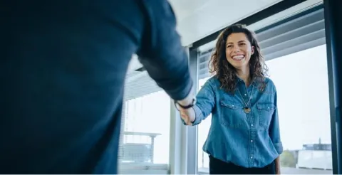 Professional handshake in modern office