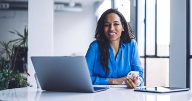 "Human resource manager sitting at desk with laptop"